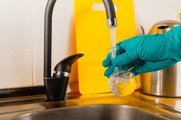 water purification specialist tap water pours into a glass flask.