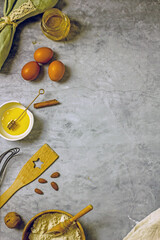 Ingredients for baking sugar-free   cake with honey. Flour, eggs, honey, nuts, spices on a gray background, top view, flat lay, copy space. Homemade honey pie recipe