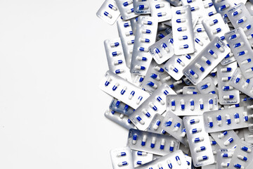 Blue and white capsule pills in blister packs