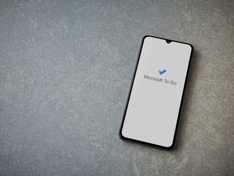 Lod, Israel - July 8, 2020: Microsoft To Do app launch screen with logo on the display of a black mobile smartphone on ceramic stone background. Top view flat lay with copy space.
