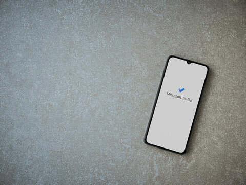 Lod, Israel - July 8, 2020: Microsoft To Do app launch screen with logo on the display of a black mobile smartphone on ceramic stone background. Top view flat lay with copy space.