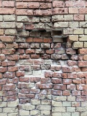 Beautiful light background of an old brick wall with a visible recess in the center
