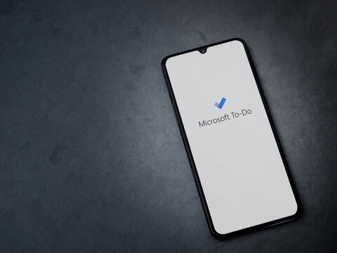 Lod, Israel - July 8, 2020: Microsoft To Do app launch screen with logo on the display of a black mobile smartphone on dark marble stone background. Top view flat lay with copy space.