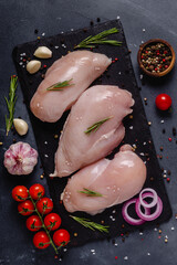 Raw chicken fillet with spices and herbs.