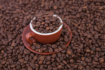 Cup of coffee on the coffee beans background