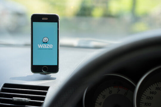 GPS-based map navigation and traffic information application Waze running on an iPhone inside a car. 