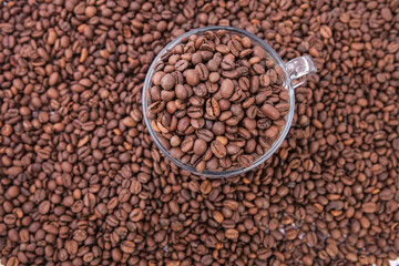 Cup of coffee on the coffee beans background