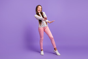 Fototapeta na wymiar Full length body size photo of dancing singing small girl wearing casual clothes isolated on bright violet color background
