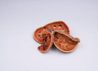 Sliced bael fruit,dried herb,put on background