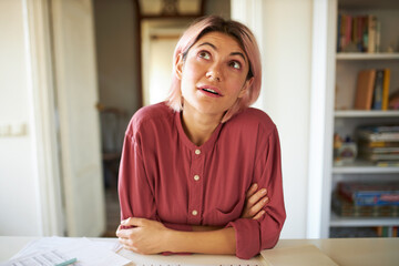 Cute student girl learning online, passing exam via webcam virtual video conference call, sitting...