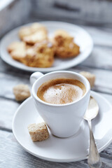 Cup of coffee on bright wooden background. Close up.	