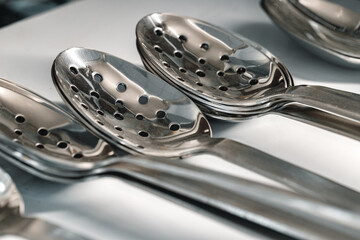 New metal kitchenware in a row close up