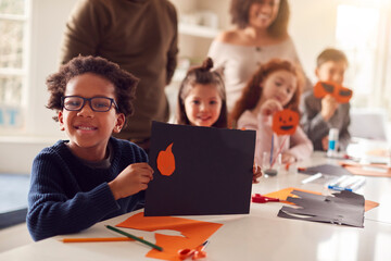 Fototapeta premium Portrait Of Children At Home With Parents Having Fun Making Craft Together