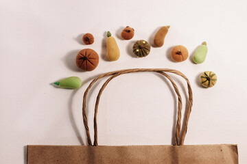 Shopping on fall season. Buying organic pumpkins and using paper bags for saving planet concept photo. Organic market.