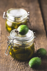 Glass Jars of Tasty Homemade Feijoa Jam on Wooden Background Vertical Dessert