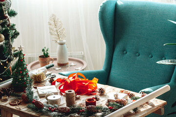 Christmas decorations on a wooden table next to a Christmas tree
