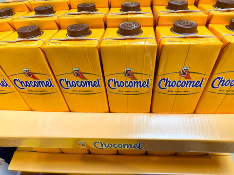 Viersen, Germany - July 9. 2020: View on isolated yellow bottles in a row with dutch chocolate drink Chocomel (focus on upper row)