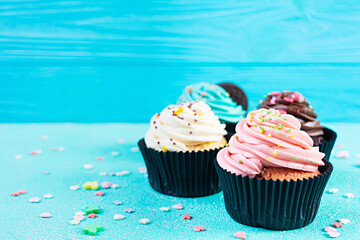 Tasty colorful cupcakes isolated on blue background. Delicious cupcake