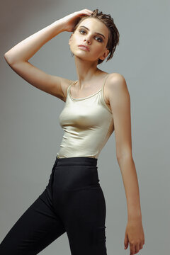 Attractive young woman in tight t-shirt and pants