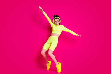 Full length body size view of her she nice attractive fit slim sporty funky cheery funky girl listening music dancing having fun isolated bright vivid shine vibrant pink fuchsia color background