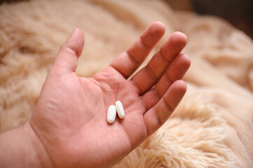 Two tablets on the palm of male closeup