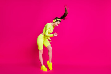 Full length body size view of her she attractive sporty fit slim cheerful girl listening rock pop music having fun enjoying rest dance isolated bright vivid shine vibrant pink fuchsia color background