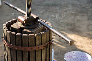 Winepress with red must and helical screw. Production of traditional Italian wines, crushing of...
