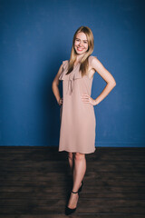 Portrait of a young girl. Photo session in the studio on a blue background.
