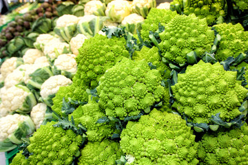 Cauliflower vegetables. Broccoli romanesco and artichokes. Vegetables. Some cauliflower, broccoli romanesco (a kind of cauliflower) and artchokes in the distance. Focus on the cauliflowers. Full image