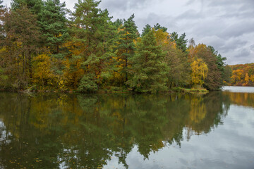 Fototapeta na wymiar Autumn landscape with colorful forest and a lake