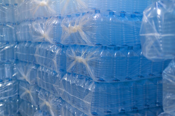 Bottling plant - Water bottling line for processing and bottling pure spring water into blue bottles. Selective focus.