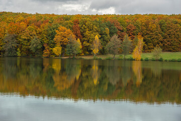 Fototapeta premium Autumn landscape with colorful forest and a lake