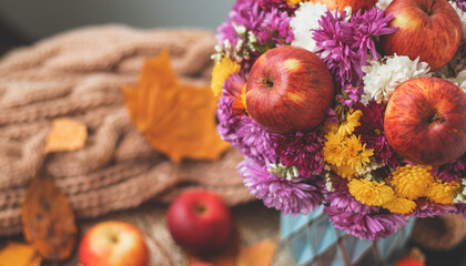 Autumn bouquet of flowers and apples. Autumn bright background with apples, chrysontema, dry leaves. September October November. Seasonal autumn background with yellow and orange colors.