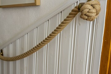 Beautiful interior view of nautical rope handrails on white wall background. Interior details...