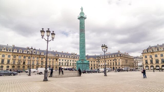 Vendome column with statue of Napoleon Bonaparte on the Place Vendome timelapse hyperlapse. Paris, France. Cloudy sky at summer day and traffic on road
