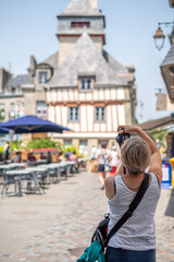 Tourist woman taking pictures in Terre du Duc Square, Quimper. French Brittany