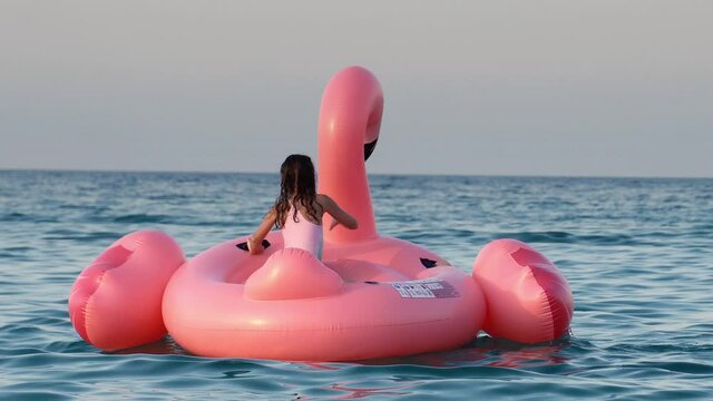 Halkidiki, Greece - 23 Jul, 2019: Children playing in the pool with flamingo water toy