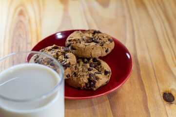 Chocolate Chip Cookies on red plate and Milk