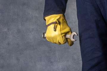 The worker holds a wrench. Free space for an inscription.