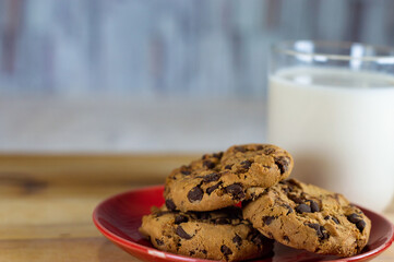 Chocolate Chip Cookies on red plate and Milk