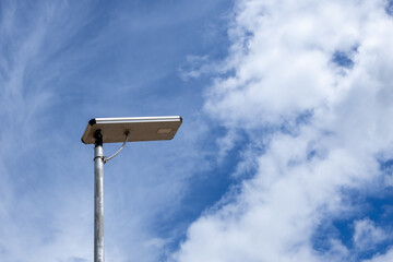 Light pole with cloud and blue sky as background