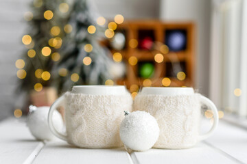 Beautiful multi-colored Christmas decorations on a light wooden table
