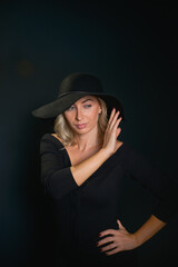 Beautiful young blonde woman with blue eyes isolated on back 