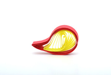 A quilling paper shape on white