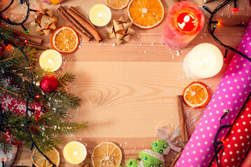 Bright christmas decoration on wooden table, copy space in the middle. Holidays theme, warm colours.