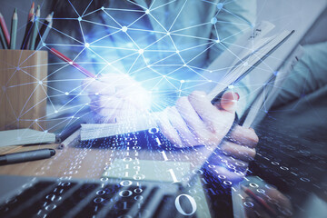 Double exposure of writing hand on background with data technology hologram. Big data concept.