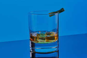 Whisky on the rocks garnished with lime.