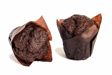 Fresh appetizing muffins with sprinkles in brown paper on an isolated white background.