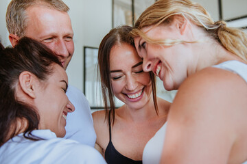 Close up of smiling friends standing in a circle