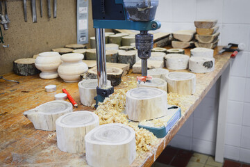 Production of wooden candle holder. Making candle holders from solid acacia wood. Woodworking workshop. Christmas candle holders. Wooden candlestick with drilled hole. DIY handmade gift.